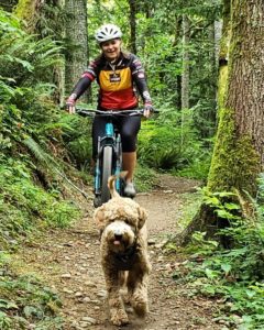 Julie Duggan riding bike with dog